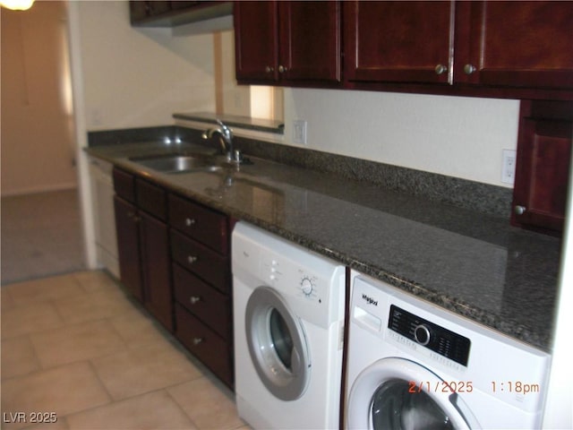 washroom featuring cabinets, sink, and washing machine and dryer