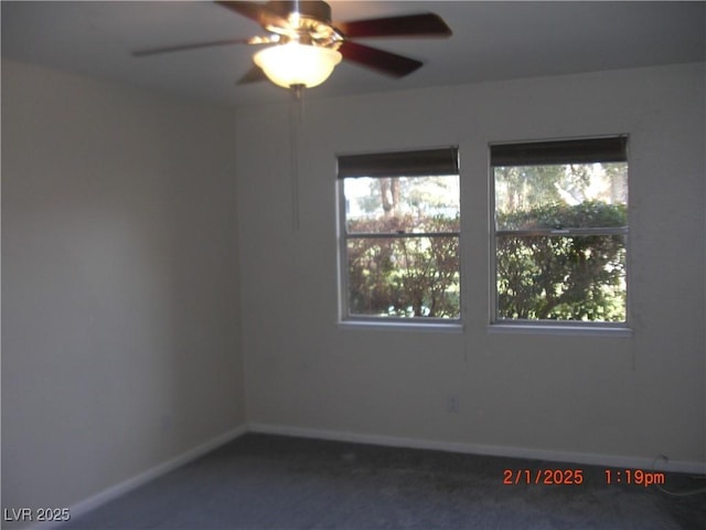 carpeted spare room with ceiling fan