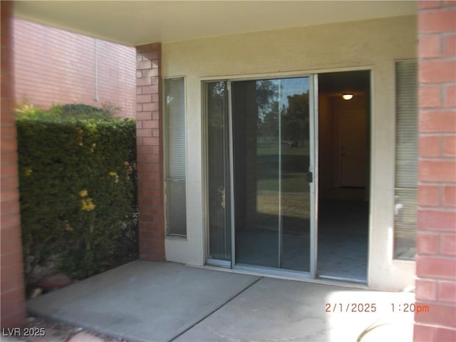 property entrance with a patio area