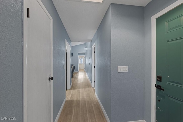 corridor with light hardwood / wood-style flooring