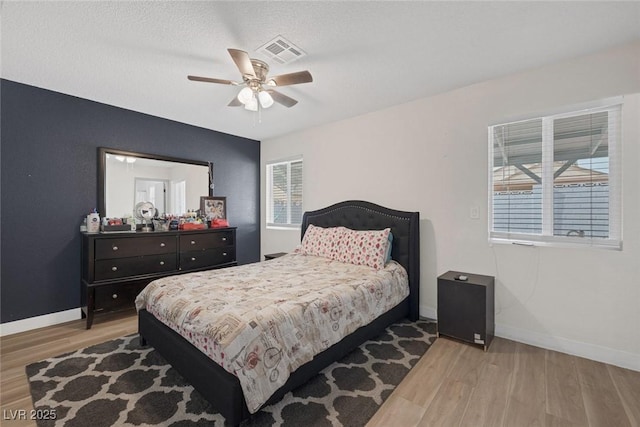 bedroom with ceiling fan and light wood-type flooring