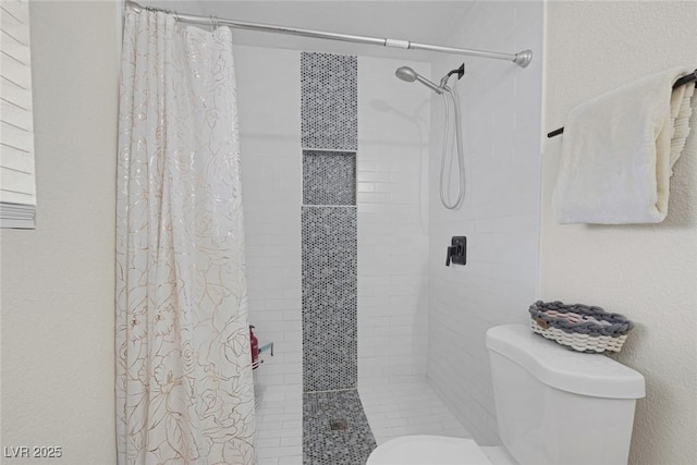 bathroom featuring toilet and a shower with shower curtain