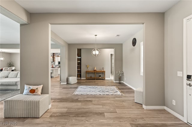 foyer with a notable chandelier and light hardwood / wood-style floors