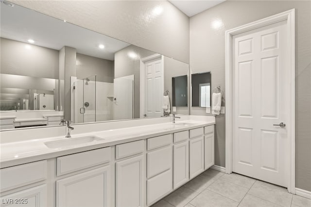 bathroom with tile patterned flooring, vanity, and a shower with shower door