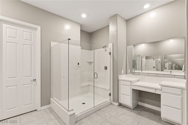 bathroom featuring tile patterned flooring, vanity, and a shower with door