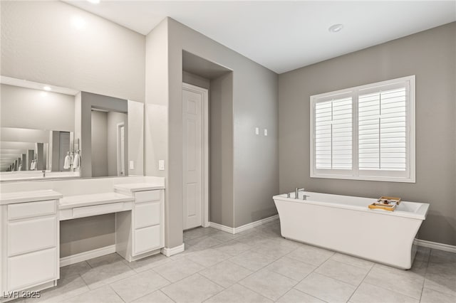 bathroom with vanity, tile patterned flooring, and a tub