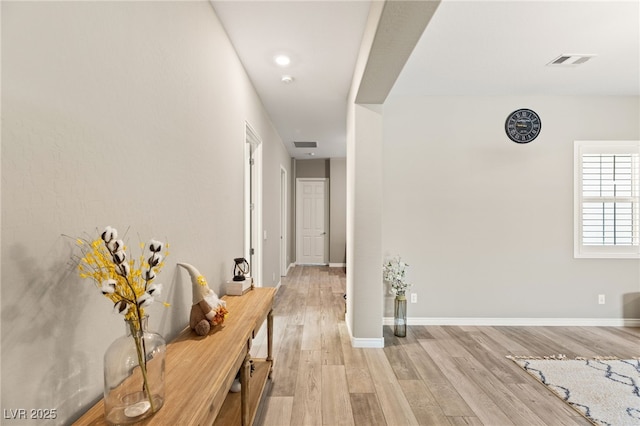 hallway with light hardwood / wood-style flooring