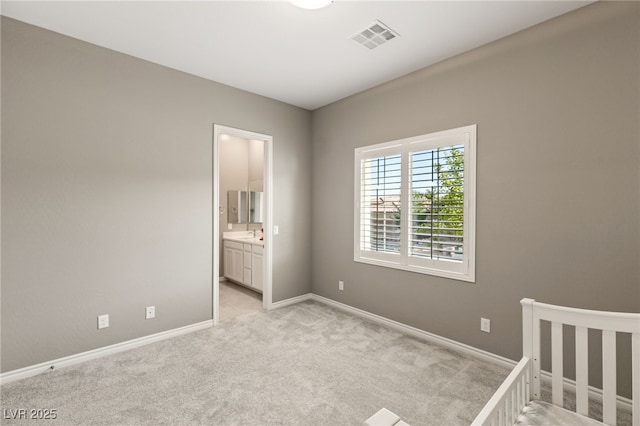 unfurnished bedroom featuring light carpet