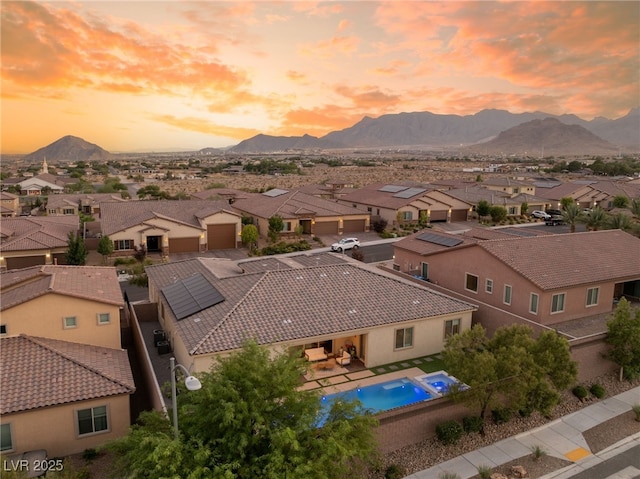 aerial view at dusk featuring a mountain view