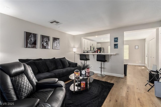 living room with light hardwood / wood-style floors