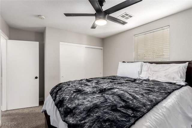 bedroom with ceiling fan, a closet, and carpet