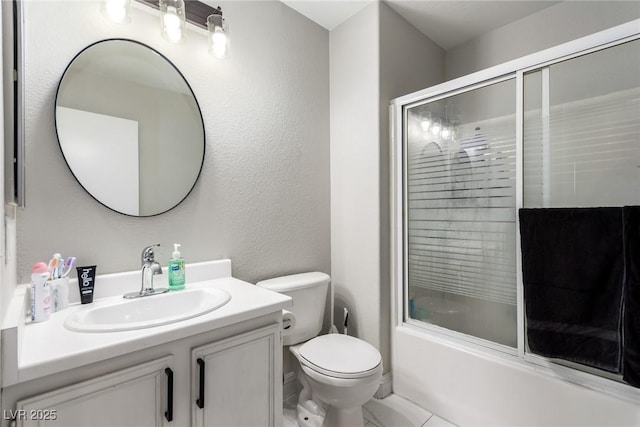 full bathroom with vanity, shower / bath combination with glass door, and toilet