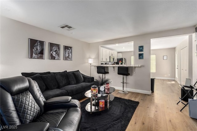 living room with light hardwood / wood-style floors