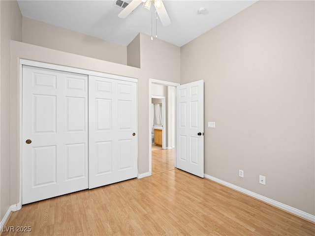 unfurnished bedroom with ceiling fan, a closet, and light wood-type flooring