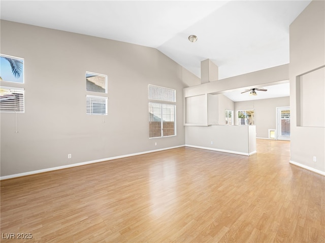 unfurnished living room with ceiling fan, high vaulted ceiling, and light hardwood / wood-style floors