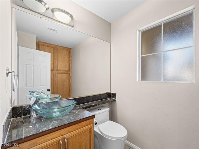 bathroom with vanity and toilet