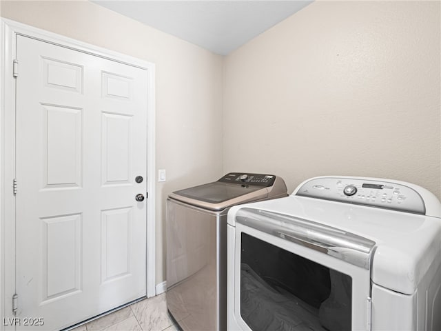 laundry area with independent washer and dryer