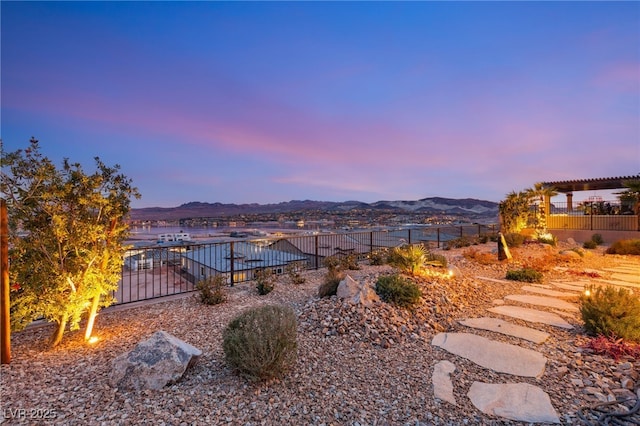 yard at dusk featuring a mountain view