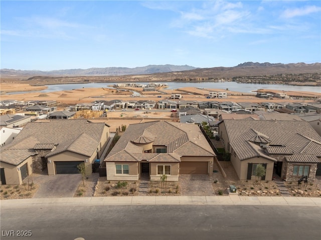 bird's eye view with a water and mountain view