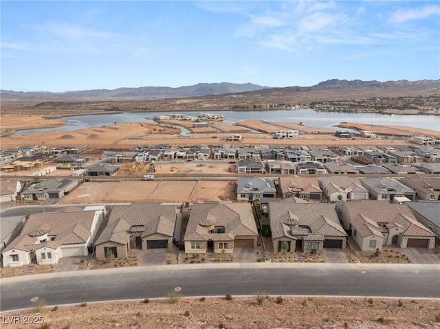 bird's eye view with a water and mountain view