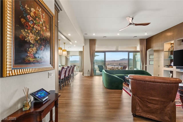 living room with hardwood / wood-style flooring, a wealth of natural light, and ceiling fan