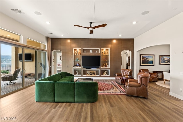 living room with hardwood / wood-style flooring and ceiling fan