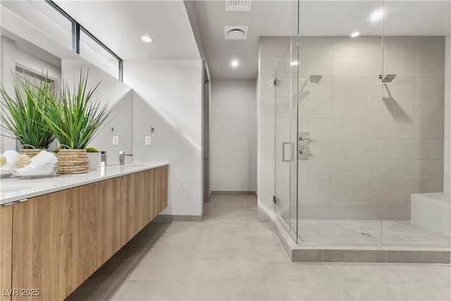 bathroom with tile patterned flooring, recessed lighting, vanity, baseboards, and a shower stall