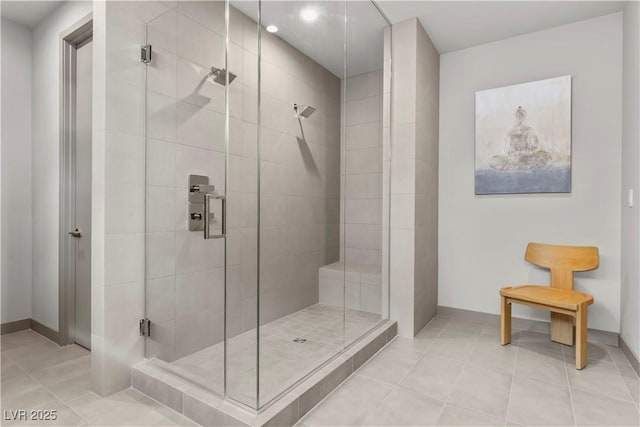 bathroom featuring a stall shower, baseboards, and tile patterned floors