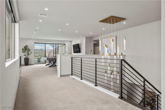 corridor with recessed lighting, visible vents, light colored carpet, and an upstairs landing