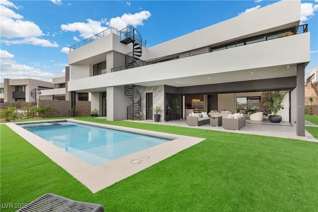 back of house featuring a yard, stucco siding, an outdoor hangout area, an outdoor pool, and stairs