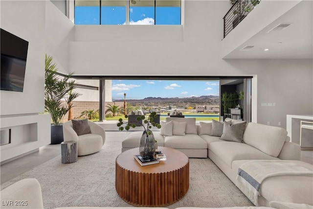 living area featuring a towering ceiling