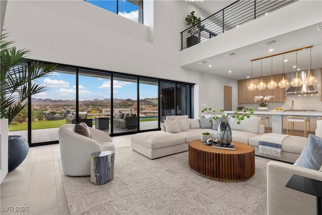 living area with light tile patterned flooring, visible vents, and recessed lighting