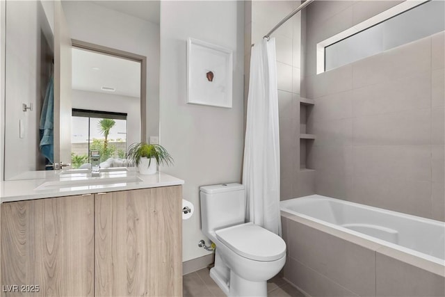 full bathroom with tiled shower / bath combo, vanity, toilet, and tile patterned floors