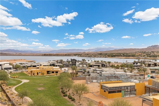 drone / aerial view featuring a residential view and a water and mountain view