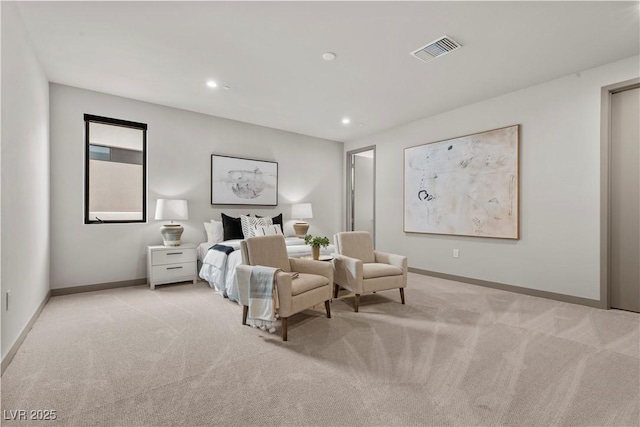 bedroom with baseboards, visible vents, and light colored carpet