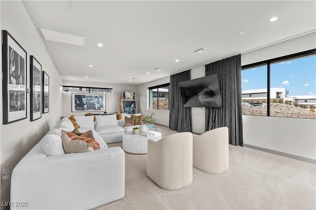 living room featuring light carpet, visible vents, and recessed lighting