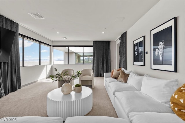 living room featuring light colored carpet, visible vents, and recessed lighting