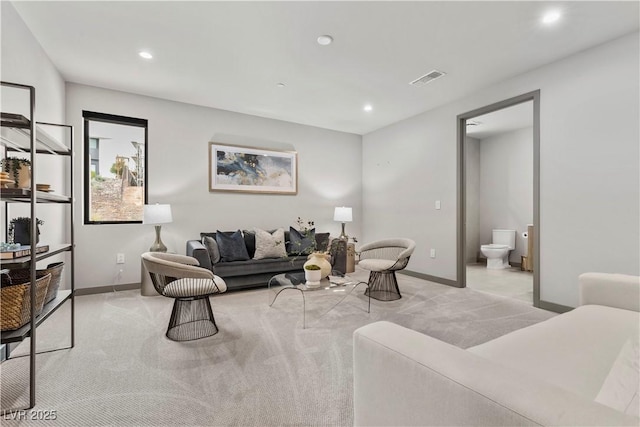 living area featuring recessed lighting, light carpet, visible vents, and baseboards