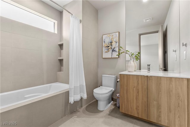 bathroom with visible vents, toilet, tile patterned floors, tiled shower / bath, and vanity