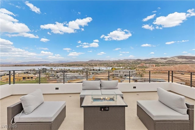 view of patio featuring an outdoor living space with a fire pit and a mountain view