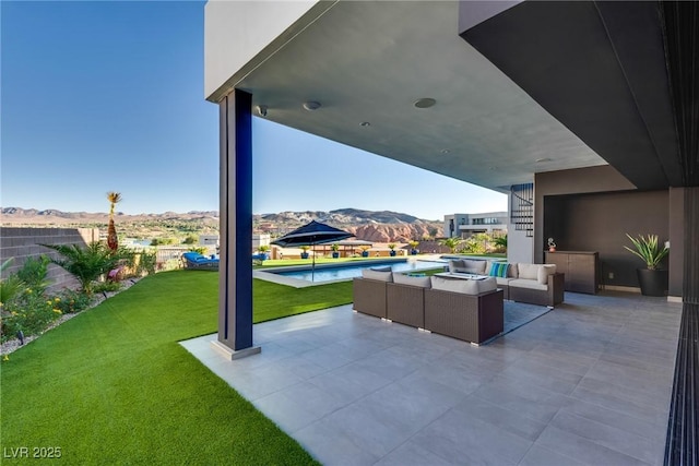 view of patio featuring outdoor lounge area, a mountain view, and an outdoor pool