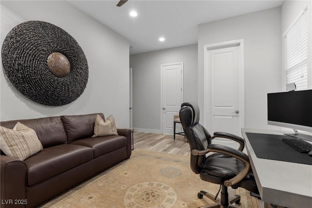 office space featuring ceiling fan and light wood-type flooring