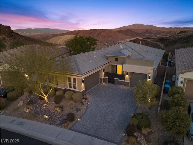 aerial view at dusk featuring a mountain view