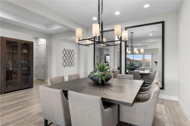 dining area featuring a notable chandelier and light hardwood / wood-style flooring