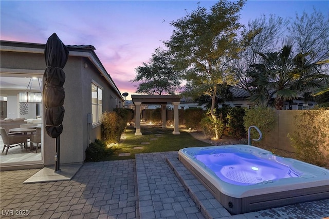 pool at dusk featuring a patio