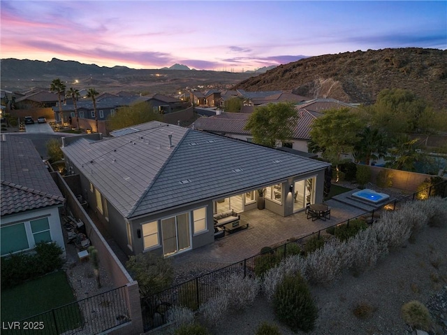 aerial view at dusk featuring a mountain view