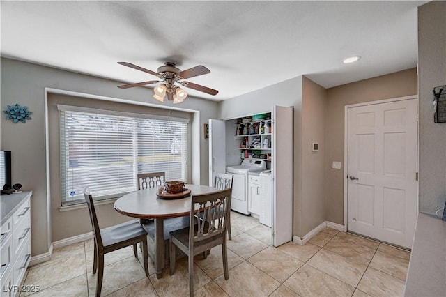 tiled dining room with ceiling fan and independent washer and dryer