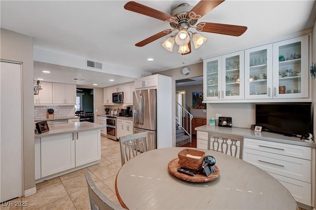 tiled dining space featuring ceiling fan