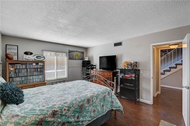 bedroom featuring dark wood-type flooring and a textured ceiling