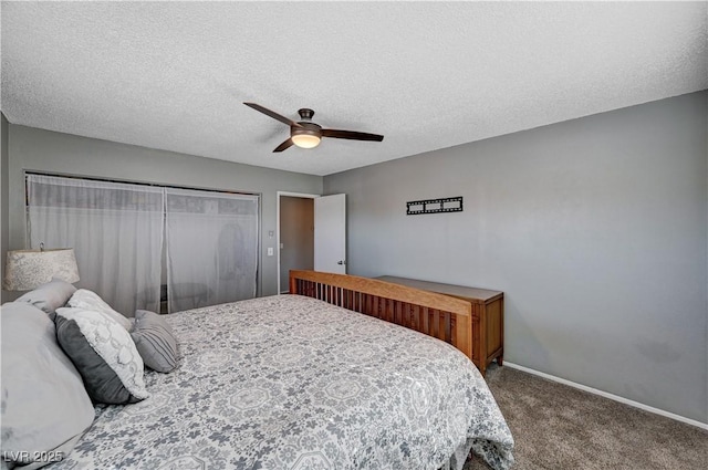 carpeted bedroom with ceiling fan and a textured ceiling